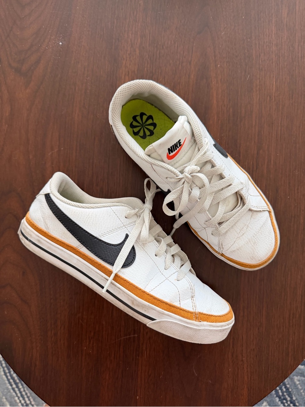 Nike White Low-Top Sneakers with Black Swoosh and Orange Trim